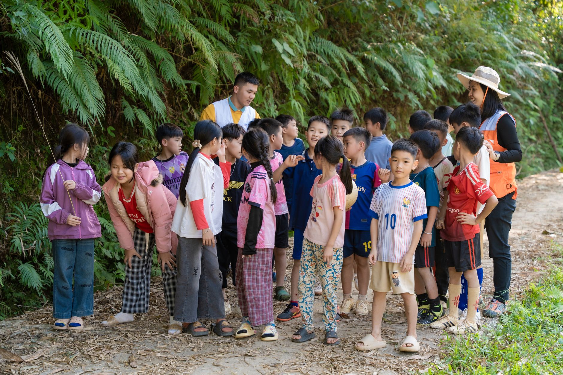 Group of children on an outdoor nature walk with two adult guides