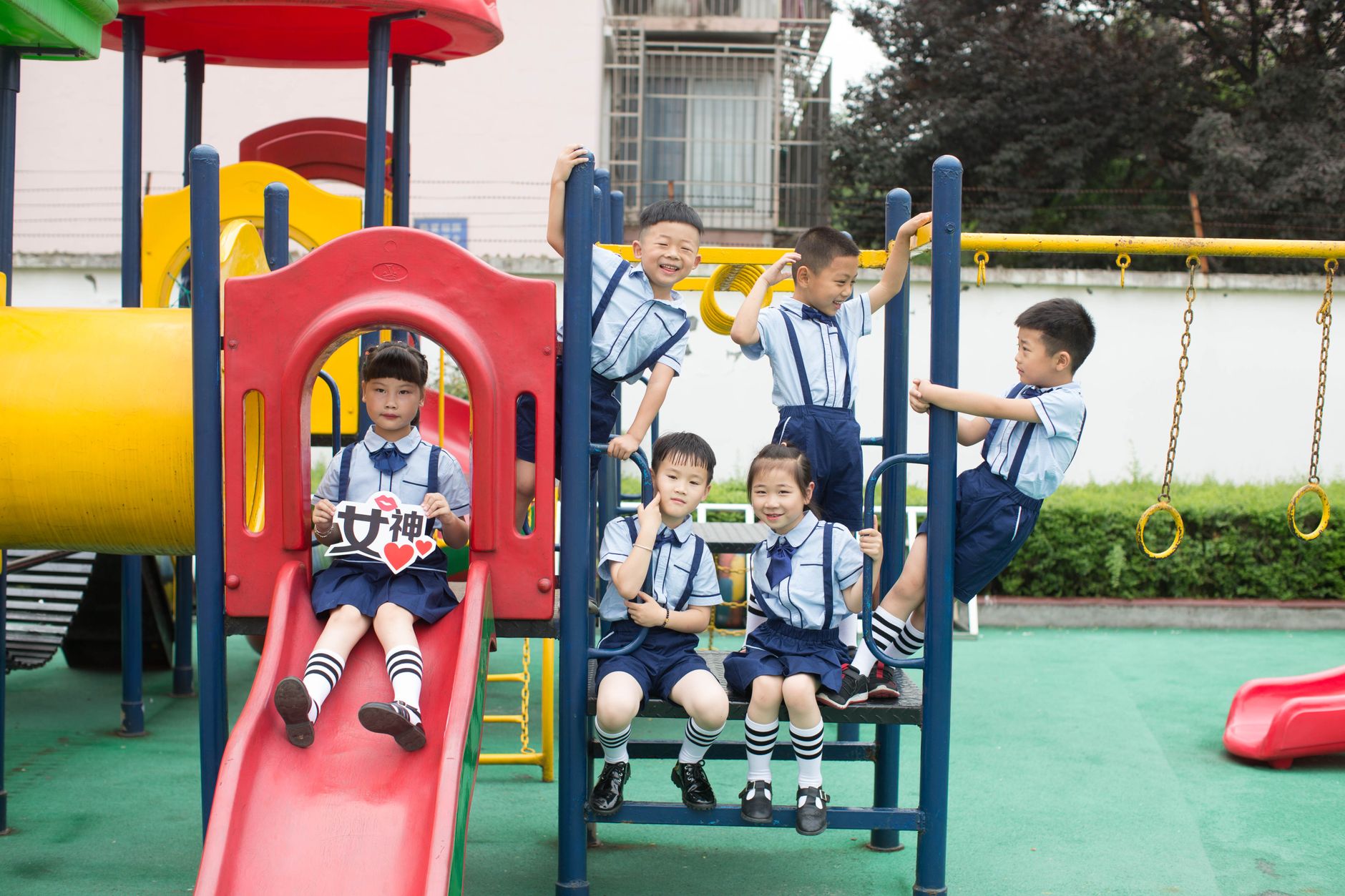 Children playing happily together at a colorful outdoor playground on a sunny day