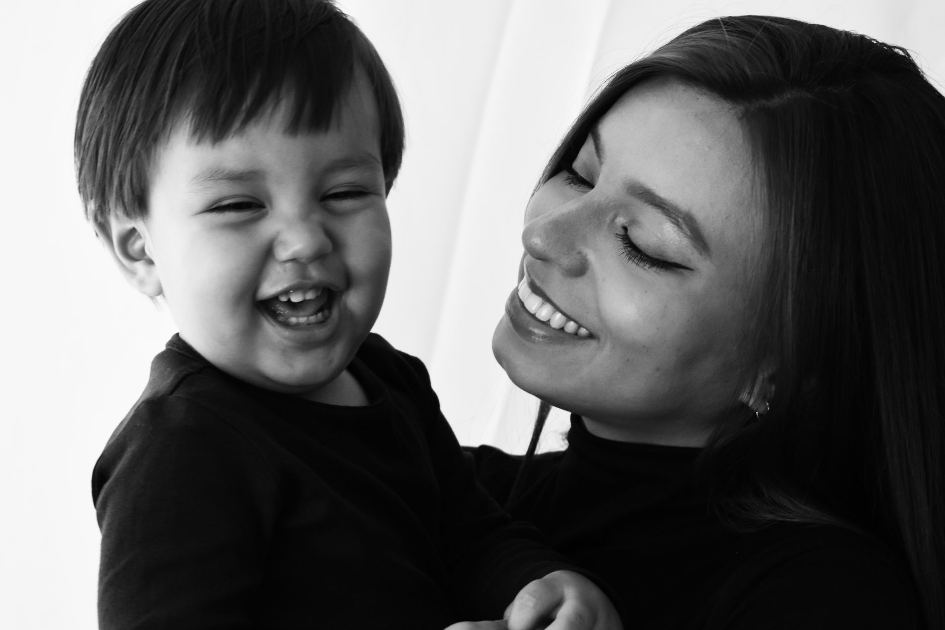 Parent and child sharing a joyful smiling moment together